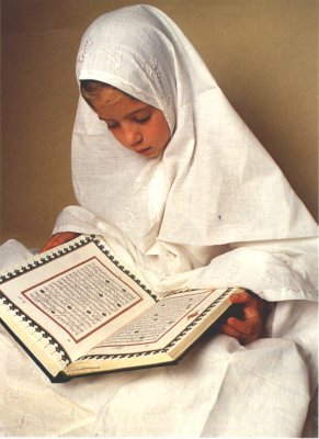 A Muslim girl reading the Holy Quran